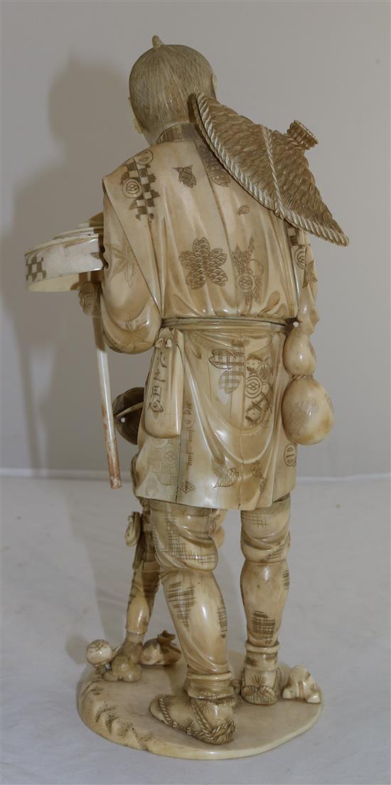 A large sectional ivory group of man and a boy, early 20th century, 30.5cm